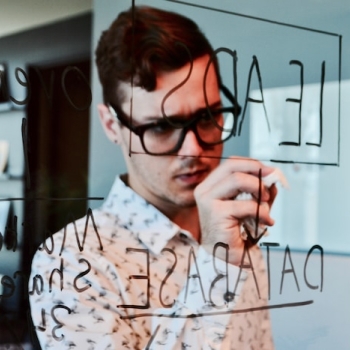 man using a clear board for writing notes