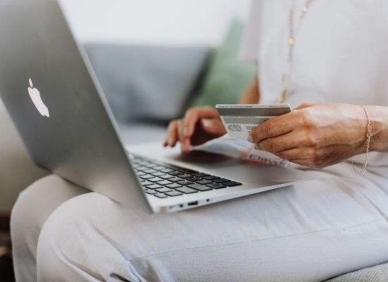 person paying for something on a laptop