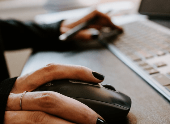 close up of a woman's hand using a mouse